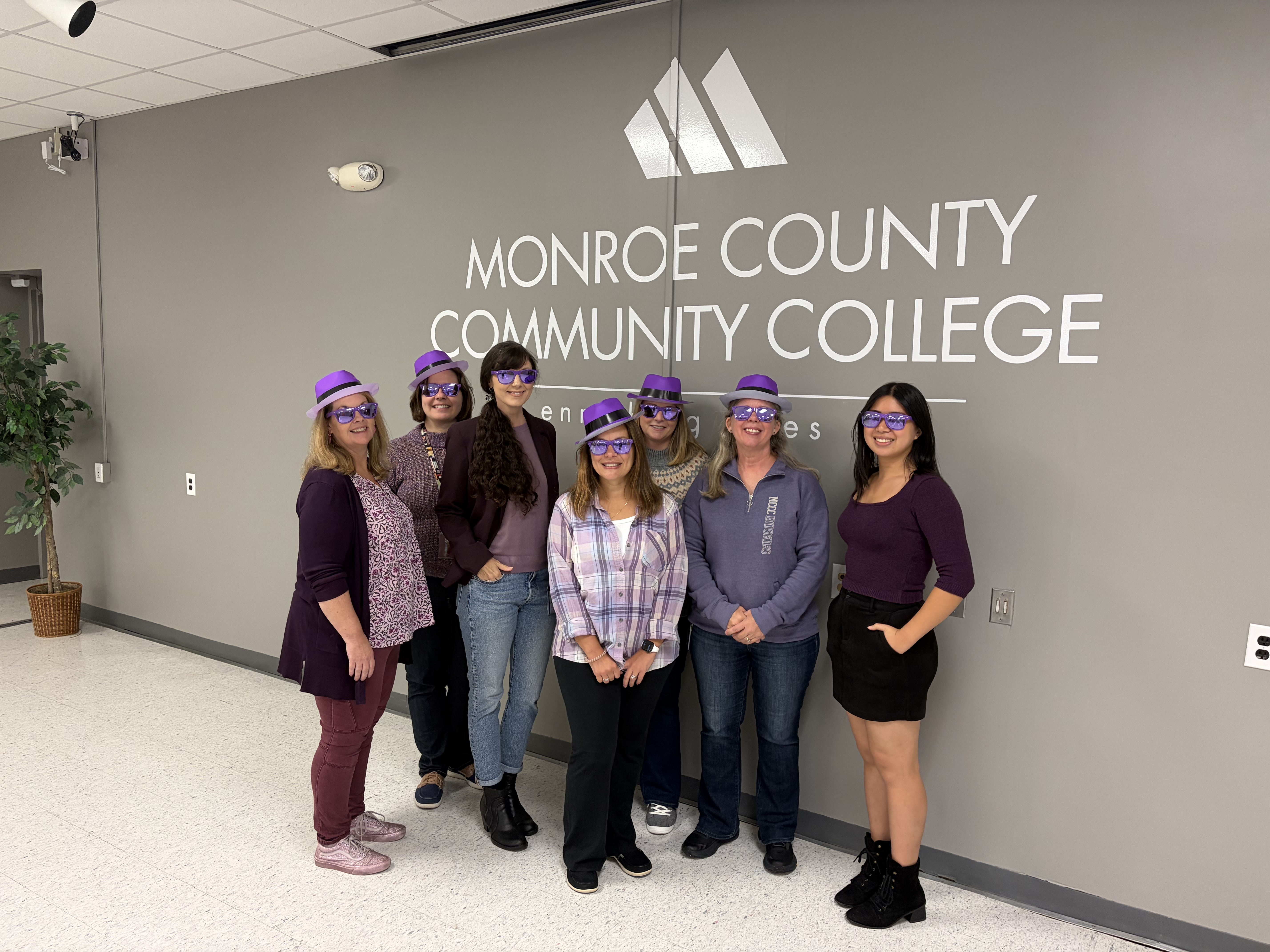 Employees dressed in purple