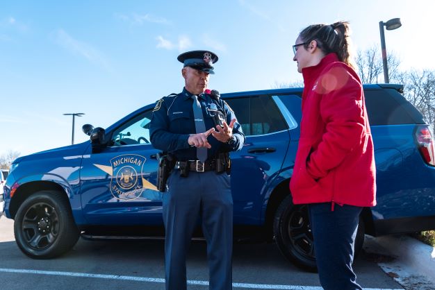 Mich. state police officer with student.