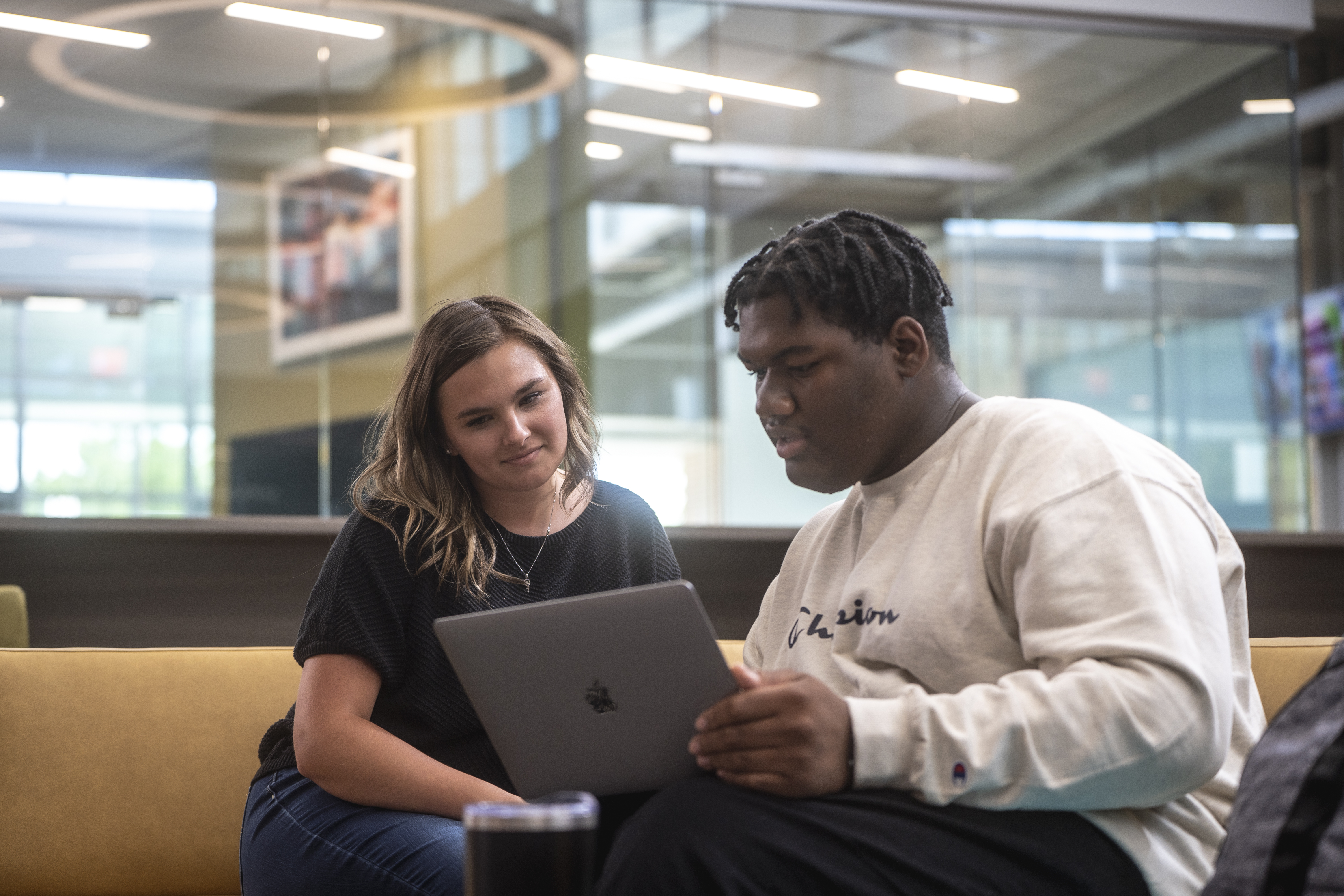 Student being helped on laptop