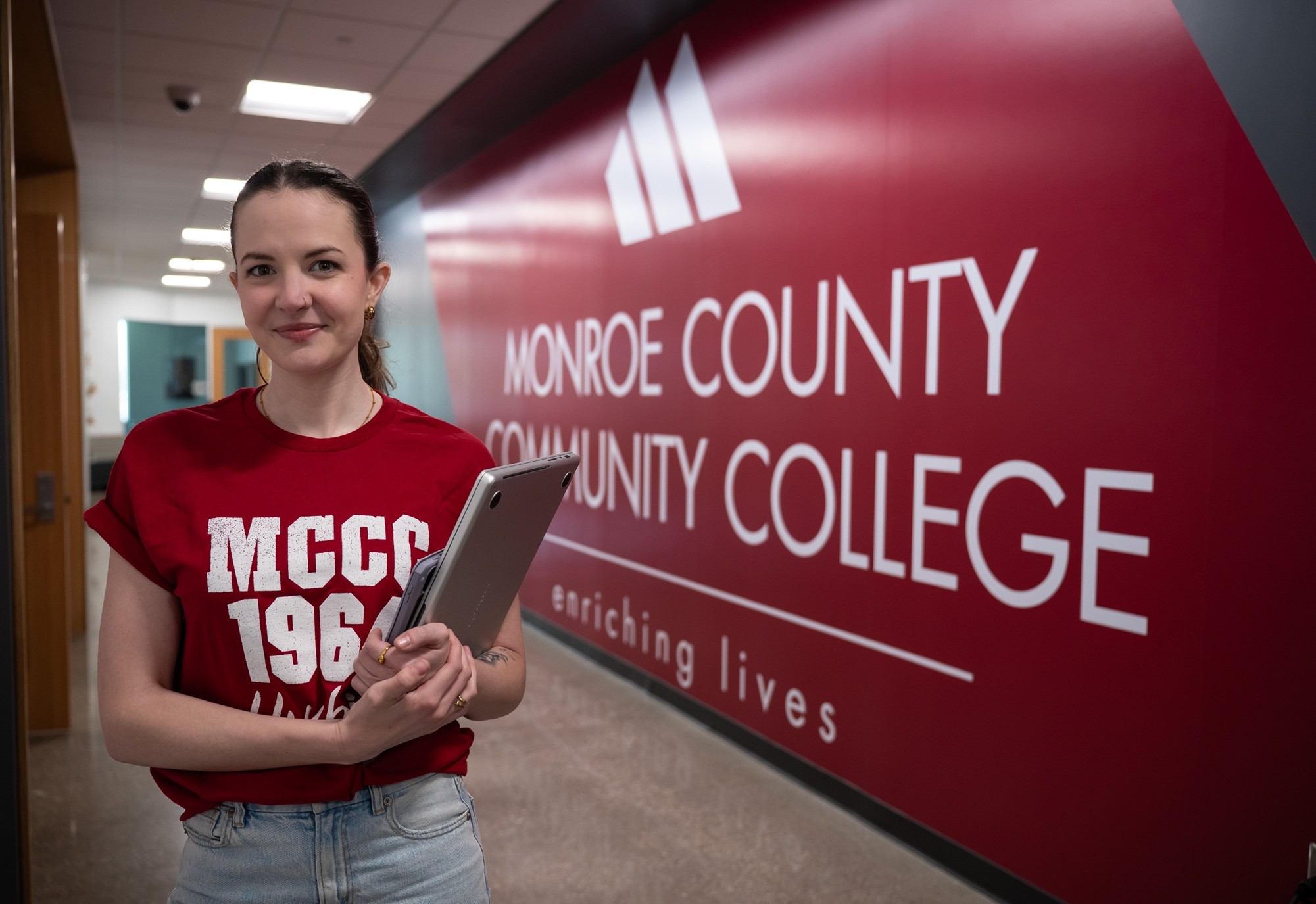 Student in hallway by MCCC sign