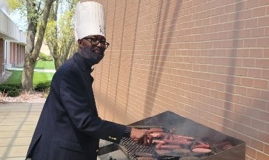 Dr. Quartey cooking hot dogs