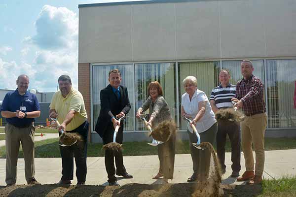 Officials participate in yesterday's ceremonial groundbreaking for an addition to the college's Life Sciences Building.