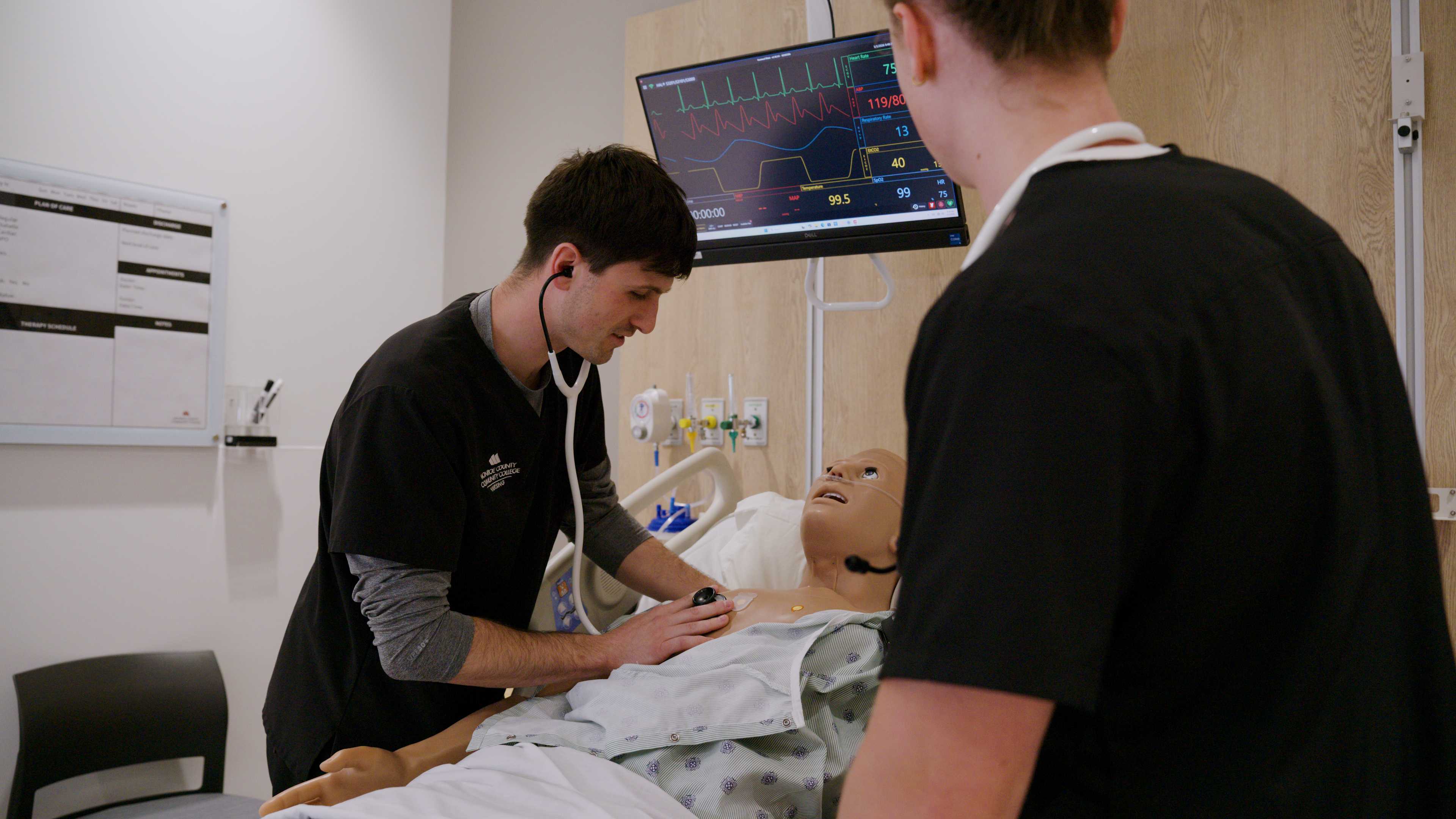 Austin Kronk working on patient in lab.
