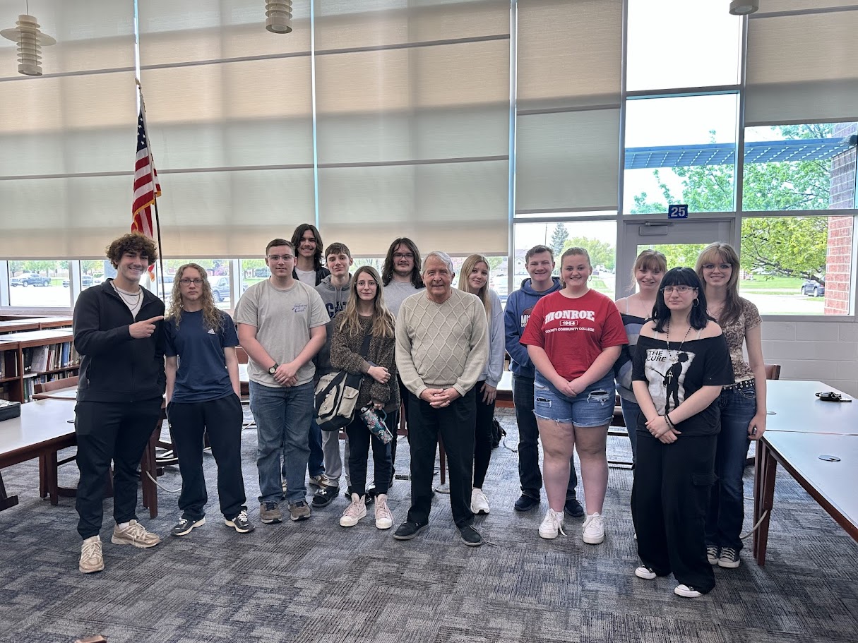 Don Roof poses with Dundee High School students after the announcement of the Roof Dundee Promise Scholarship.