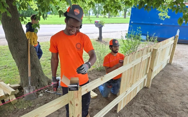 Students working on a fence