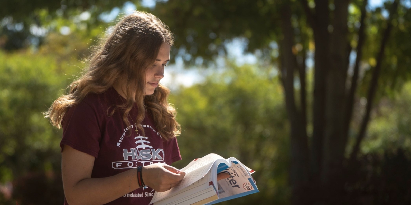 student studying outside on campus