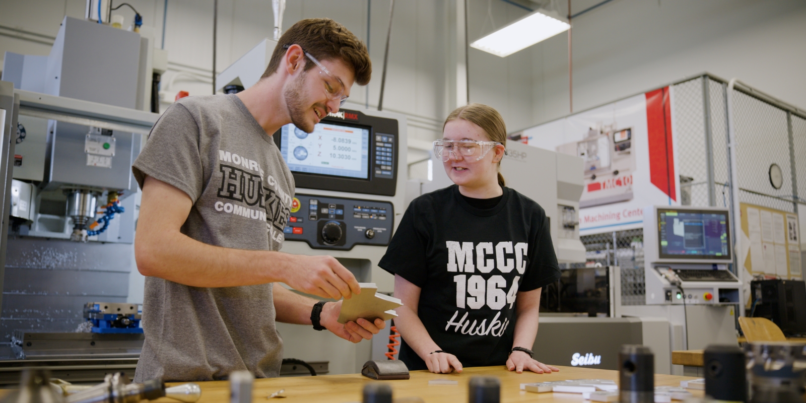 Anna Atherton works with another student in Manufacturing Lab.