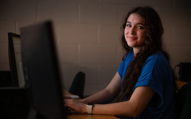 Female smiling at a computer